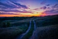 Evening road through the field near the Kurapovo village Royalty Free Stock Photo